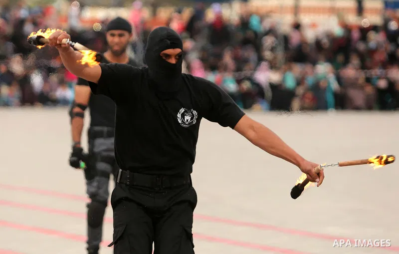 Palestinian police officers loyal to Hamas take part in a graduation ceremony in Gaza City March 30, 2017. Photo by Ashraf Amra