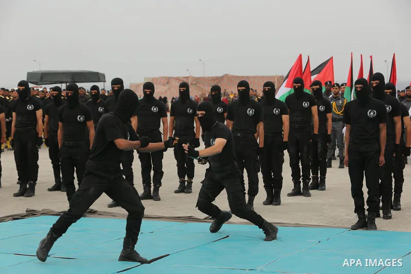 Palestinian police officers loyal to Hamas take part in a graduation ceremony in Gaza City March 30, 2017. Photo by Ashraf Amra