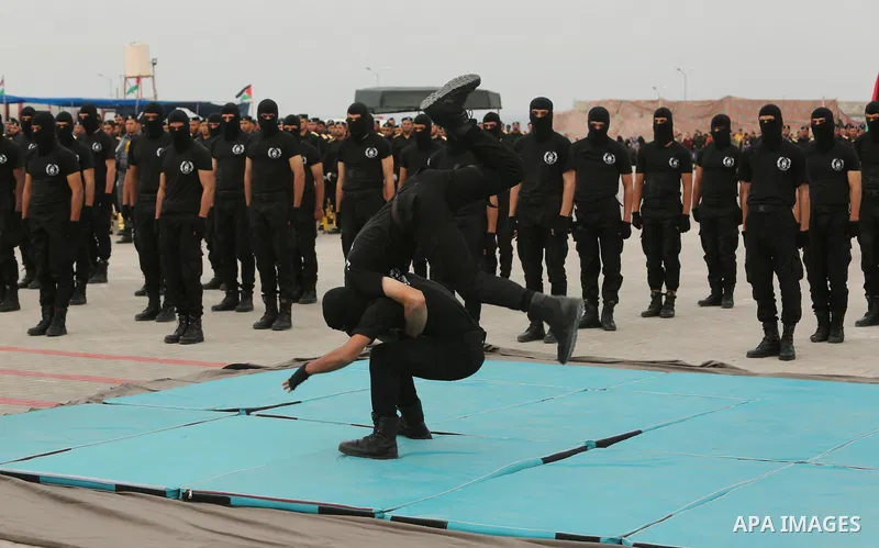 Palestinian police officers loyal to Hamas take part in a graduation ceremony in Gaza City March 30, 2017. Photo by Ashraf Amra