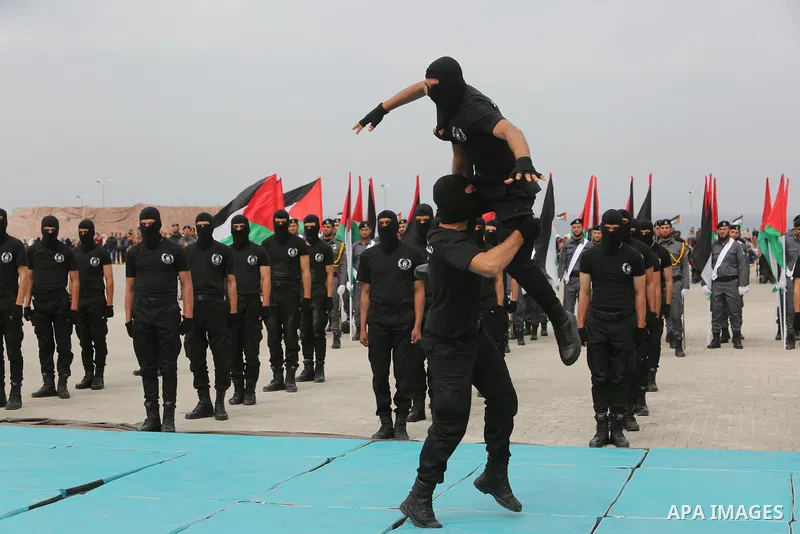 Palestinian police officers loyal to Hamas take part in a graduation ceremony in Gaza City March 30, 2017. Photo by Ashraf Amra