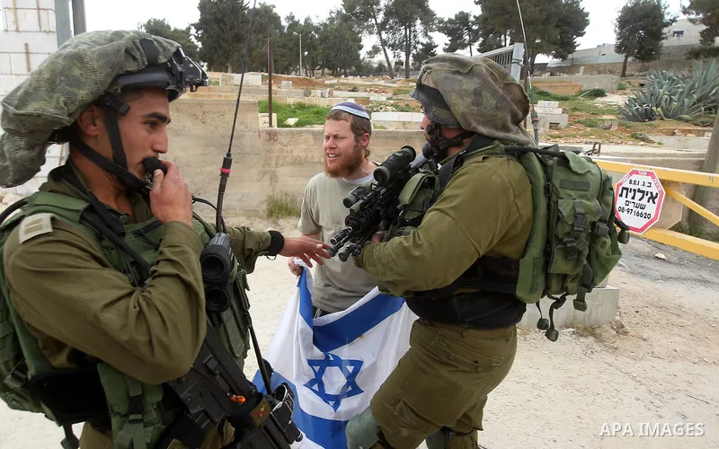 Israeli soldiers take position during a protest to mark land day in the West Bank city of Hebron March 30, 2017. Photo by Wisam Hashlamoun