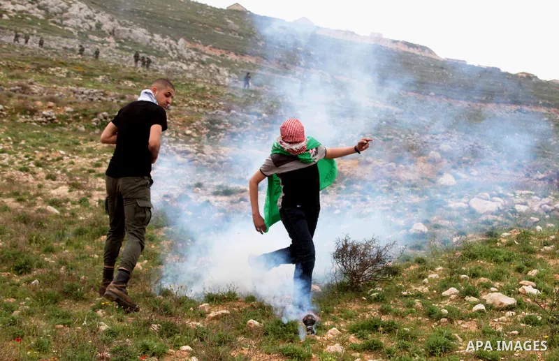 Palestinian demonstrators clash with Israel forces following a protest to mark land day in village of Madama, south of Nablus, on March 30, 2017 in the Israeli occupied West Bank. Land Day marks the killing of six Arab I...