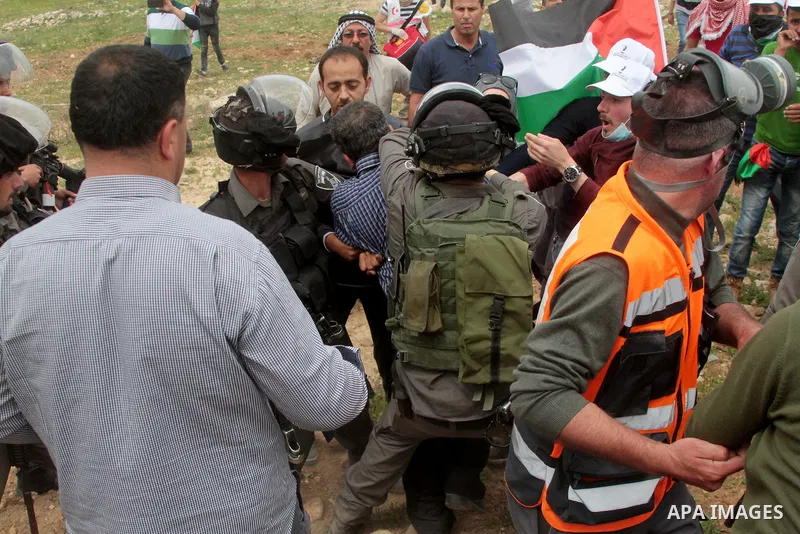 Israeli soliders scuffle with a Palestinian demonstrator during clashes following a protest to mark land day in village of Madama, south of Nablus, on March 30, 2017 in the Israeli occupied West Bank. Land Day marks the...