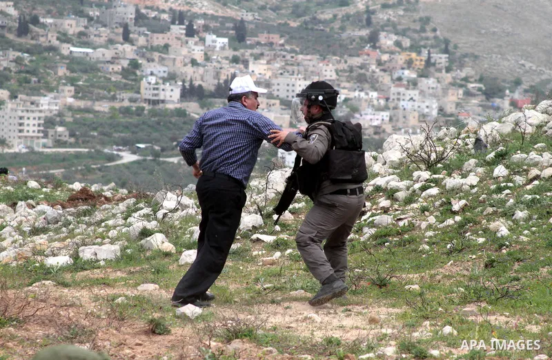 An Israeli solider scuffles with a Palestinian demonstrator during clashes following a protest to mark land day in village of Madama, south of Nablus, on March 30, 2017 in the Israeli occupied West Bank. Land Day marks t...