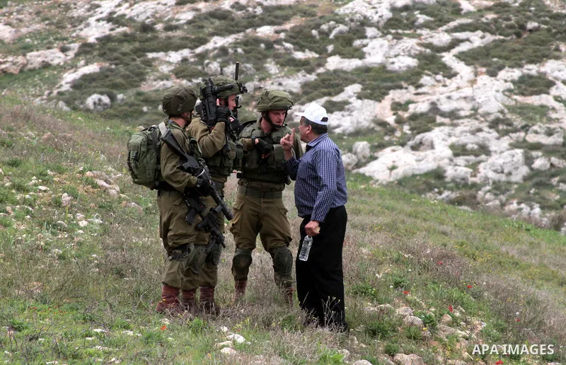 Israeli soliders scuffle with a Palestinian demonstrator during clashes following a protest to mark land day in village of Madama, south of Nablus, on March 30, 2017 in the Israeli occupied West Bank. Land Day marks the...