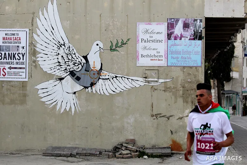 Participants run in the biblical West Bank town of Bethlehem during the 5th Palestine Marathon on March 31, 2017. Photo by Wisam Hashlamoun