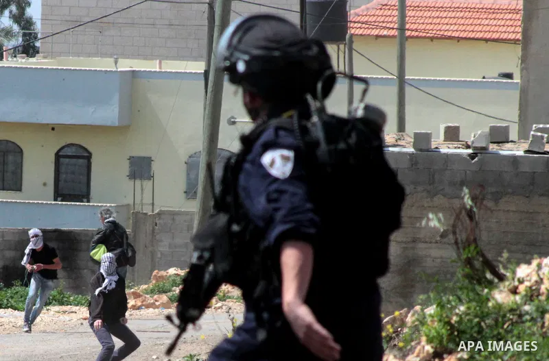 Palestinian protesters hurl stones towards Israeli security forces during clashes following a weekly demonstration against the expropriation of Palestinian land by Israel in the village of Kfar Qaddum, near Nablus, in th...