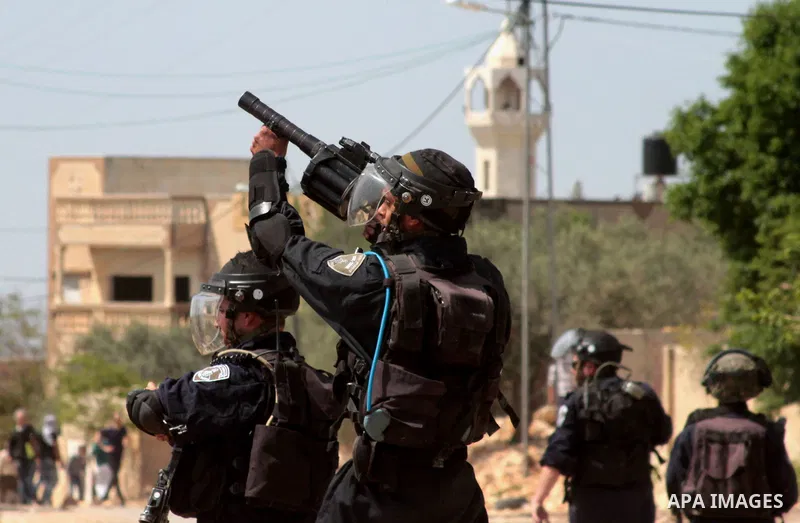 Israeli security forces aim their weapons towards Palestinian protesters during clashes following a weekly demonstration against the expropriation of Palestinian land by Israel in the village of Kfar Qaddum, near Nablus,...