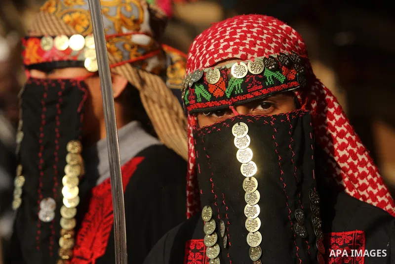 A Palestinian bedouin girl wears traditional dress and holds a sword during a rally marking the 41st anniversary of Land Day, in Deir el-Balah, Central Gaza Strip, on March 31, 2017. Land Day marks the killing of six Ara...