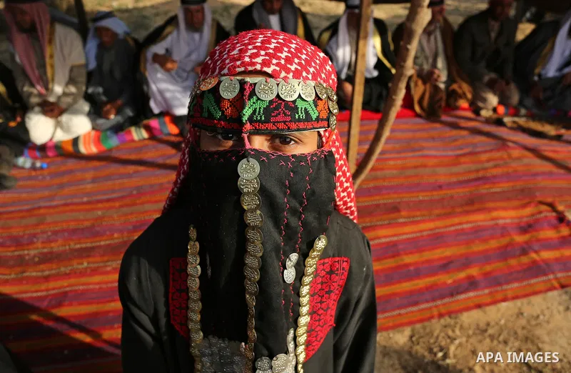 A Palestinian bedouin girl wears traditional dress and poses for a photo during a rally marking the 41st anniversary of Land Day, in Deir el-Balah, Central Gaza Strip, on March 31, 2017. Land Day marks the killing of six...