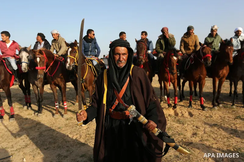 A Palestinian bedouin man wears traditional dress holds a sword during a rally marking the 41st anniversary of Land Day, in Deir el-Balah, Central Gaza Strip, on March 31, 2017. Land Day marks the killing of six Arab Isr...