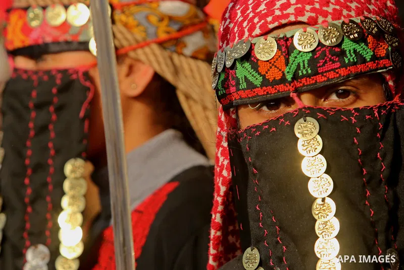 A Palestinian bedouin girl wears traditional dress and holds a sword during a rally marking the 41st anniversary of Land Day, in Deir el-Balah, Central Gaza Strip, on March 31, 2017. Land Day marks the killing of six Ara...