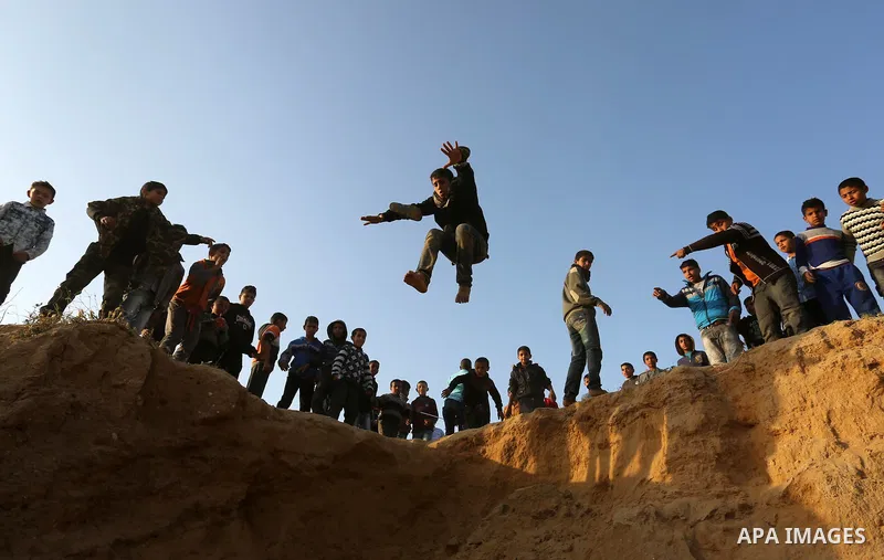 A Palestinian bedouin boy jumps during a rally marking the 41st anniversary of Land Day, in Deir el-Balah, Central Gaza Strip, on March 31, 2017. Land Day marks the killing of six Arab Israelis during 1976 demonstrations...