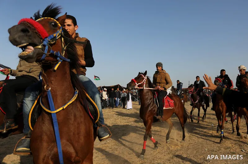 Palestinian Bedouins ride horses during a rally marking the 41st anniversary of Land Day, in Deir el-Balah, Central Gaza Strip, on March 31, 2017. Land Day marks the killing of six Arab Israelis during 1976 demonstration...