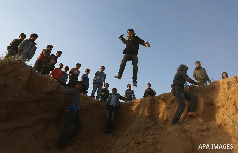 A Palestinian bedouin boy jumps during a rally marking the 41st anniversary of Land Day, in Deir el-Balah, Central Gaza Strip, on March 31, 2017. Land Day marks the killing of six Arab Israelis during 1976 demonstrations...