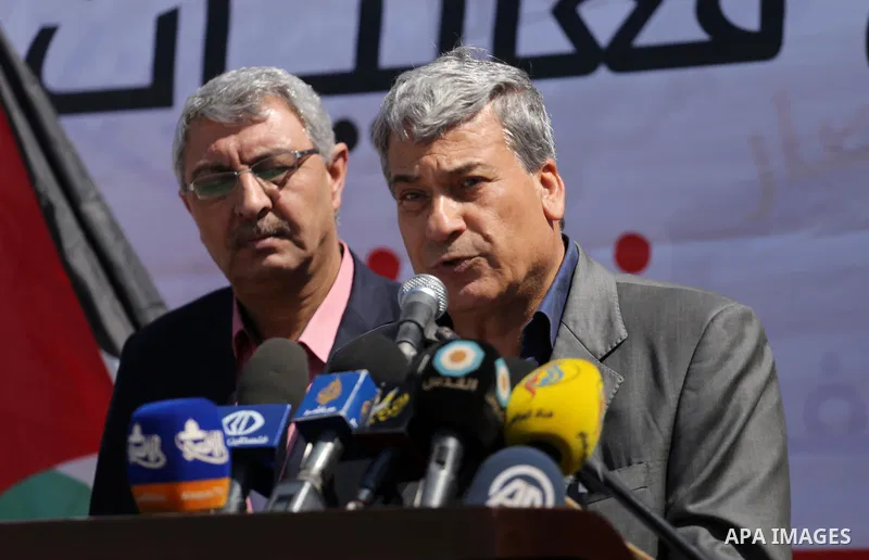 Palestinian activists take part in a rally titled "save Gaza" against the Israeli occupation and Gaza blockade in front of a tower which was destroy during the 50-day war between Israel and Hamas militants in the summer...