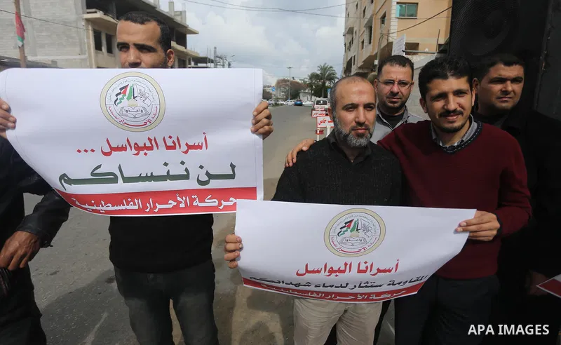 Palestinians hold placards during a protest to show solidarity with Palestinian prisoners held in Israeli Jails, in front of Red cross office in Gaza city, on April 2, 2017. Photo by Mohammed Asad