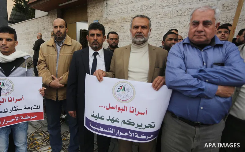 Palestinians hold placards during a protest to show solidarity with Palestinian prisoners held in Israeli Jails, in front of Red cross office in Gaza city, on April 2, 2017. Photo by Mohammed Asad