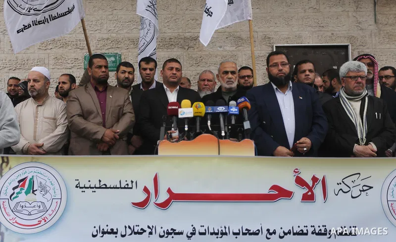Palestinians hold placards during a protest to show solidarity with Palestinian prisoners held in Israeli Jails, in front of Red cross office in Gaza city, on April 2, 2017. Photo by Mohammed Asad