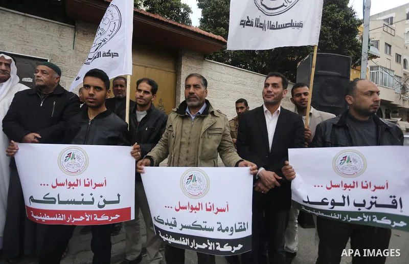 Palestinians hold placards during a protest to show solidarity with Palestinian prisoners held in Israeli Jails, in front of Red cross office in Gaza city, on April 2, 2017. Photo by Mohammed Asad