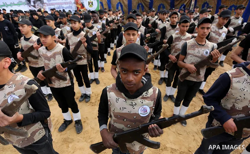 Palestinian high-school students show off their skills during a graduation ceremony from a military school course organised by the Palestinian security forces in Gaza strip, in Gaza City, on April 2, 2017. Photo by Ashra...