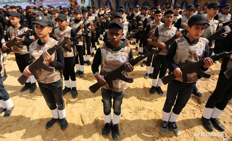 Palestinian high-school students show off their skills during a graduation ceremony from a military school course organised by the Palestinian security forces in Gaza strip, in Gaza City, on April 2, 2017. Photo by Ashra...