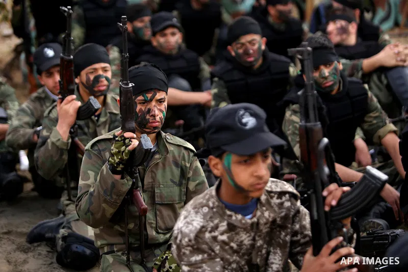 Palestinian high-school students show off their skills during a graduation ceremony from a military school course organised by the Palestinian security forces in Gaza strip, in Gaza City, on April 2, 2017. Photo by Ashra...
