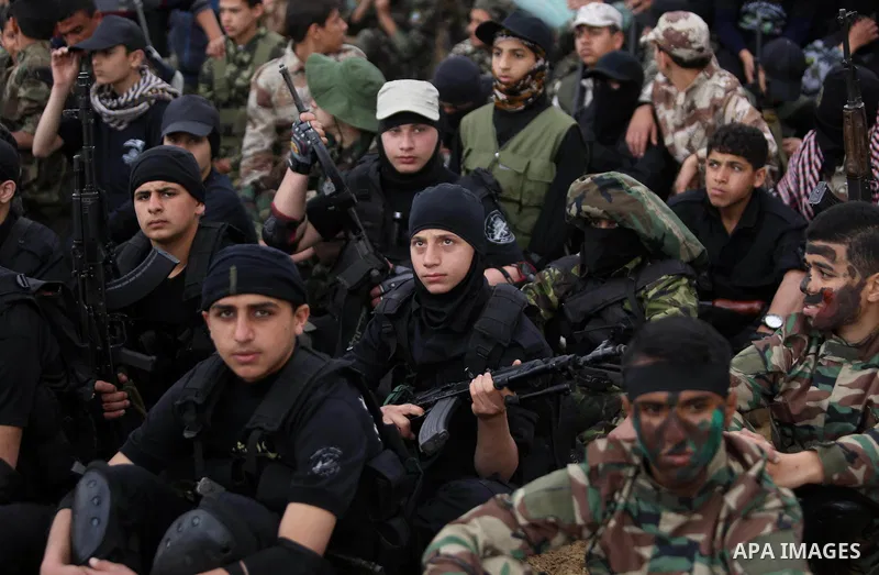 Palestinian high-school students show off their skills during a graduation ceremony from a military school course organised by the Palestinian security forces in Gaza strip, in Gaza City, on April 2, 2017. Photo by Ashra...