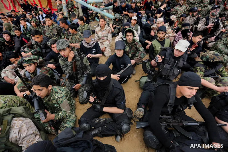 Palestinian high-school students show off their skills during a graduation ceremony from a military school course organised by the Palestinian security forces in Gaza strip, in Gaza City, on April 2, 2017. Photo by Ashra...