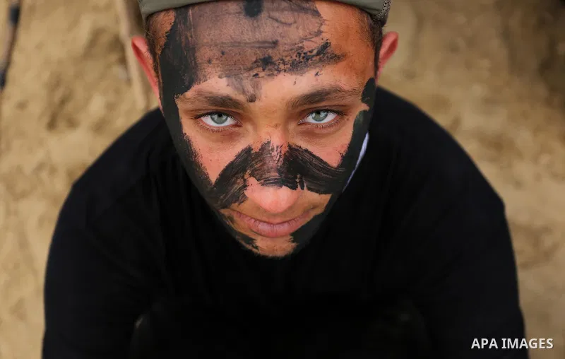 Palestinian high-school students show off their skills during a graduation ceremony from a military school course organised by the Palestinian security forces in Gaza strip, in Gaza City, on April 2, 2017. Photo by Ashra...