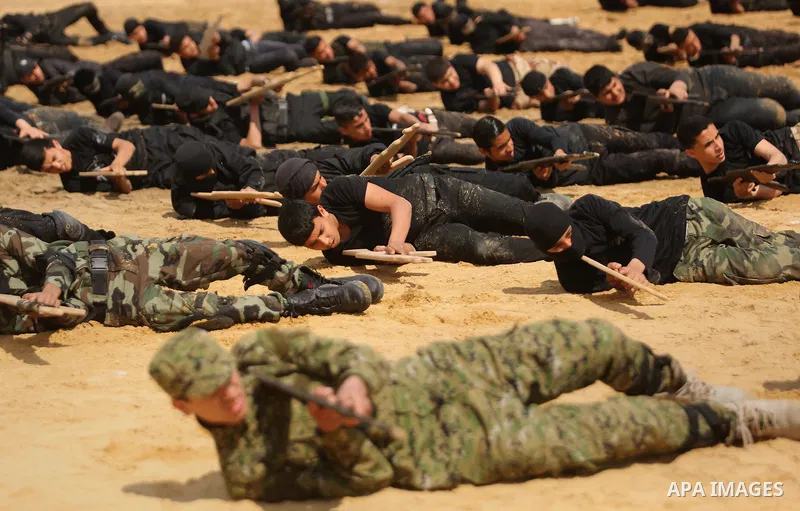 Palestinian high-school students show off their skills during a graduation ceremony from a military school course organised by the Palestinian security forces in Gaza strip, in Gaza City, on April 2, 2017. Photo by Ashra...
