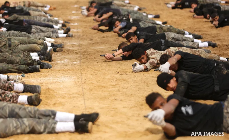 Palestinian high-school students show off their skills during a graduation ceremony from a military school course organised by the Palestinian security forces in Gaza strip, in Gaza City, on April 2, 2017. Photo by Ashra...