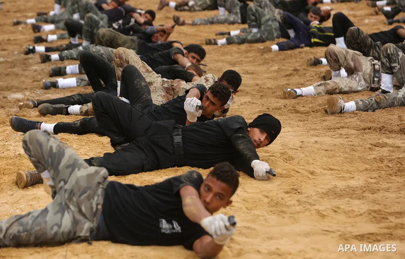 Palestinian high-school students show off their skills during a graduation ceremony from a military school course organised by the Palestinian security forces in Gaza strip, in Gaza City, on April 2, 2017. Photo by Ashra...