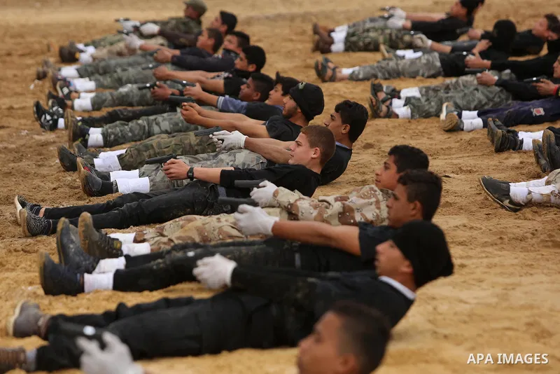 Palestinian high-school students show off their skills during a graduation ceremony from a military school course organised by the Palestinian security forces in Gaza strip, in Gaza City, on April 2, 2017. Photo by Ashra...