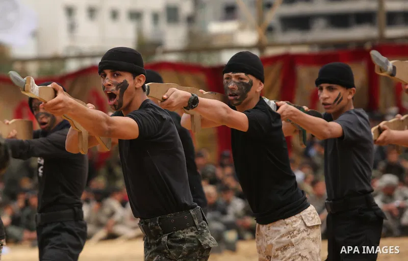 Palestinian high-school students show off their skills during a graduation ceremony from a military school course organised by the Palestinian security forces in Gaza strip, in Gaza City, on April 2, 2017. Photo by Ashra...