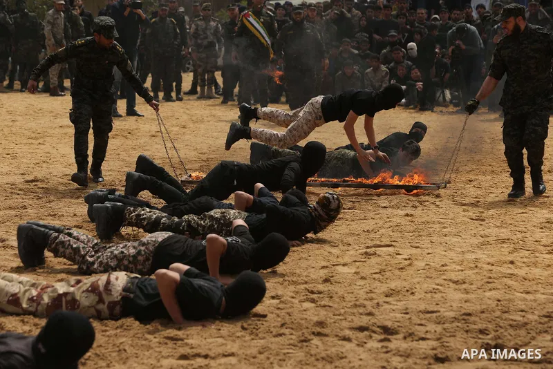 Palestinian high-school students show off their skills during a graduation ceremony from a military school course organised by the Palestinian security forces in Gaza strip, in Gaza City, on April 2, 2017. Photo by Ashra...