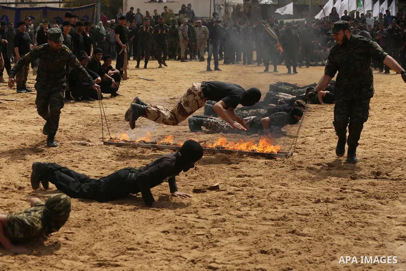 Palestinian high-school students show off their skills during a graduation ceremony from a military school course organised by the Palestinian security forces in Gaza strip, in Gaza City, on April 2, 2017. Photo by Ashra...