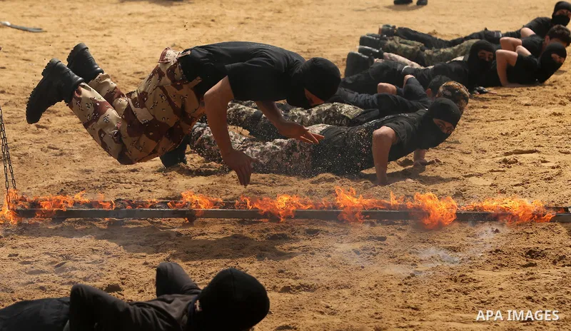 Palestinian high-school students show off their skills during a graduation ceremony from a military school course organised by the Palestinian security forces in Gaza strip, in Gaza City, on April 2, 2017. Photo by Ashra...