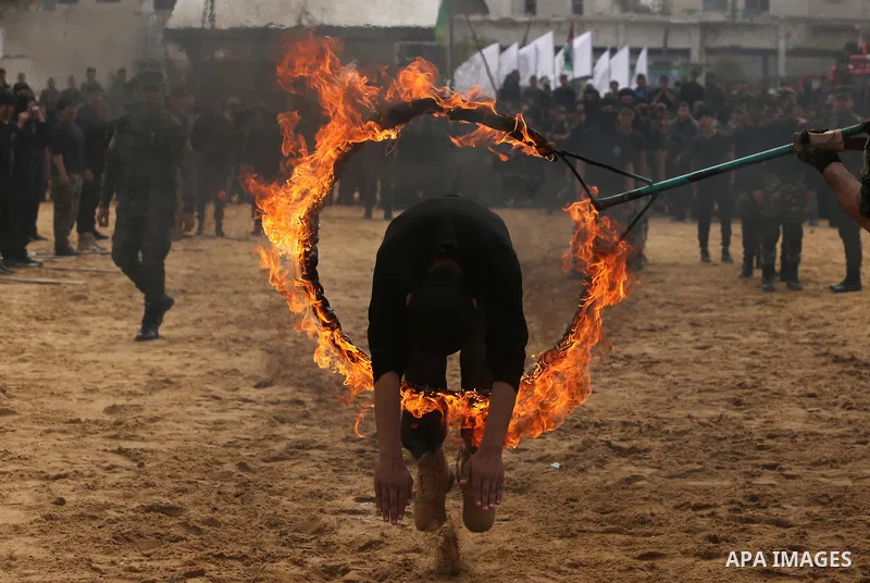 Palestinian high-school students show off their skills during a graduation ceremony from a military school course organised by the Palestinian security forces in Gaza strip, in Gaza City, on April 2, 2017. Photo by Ashra...