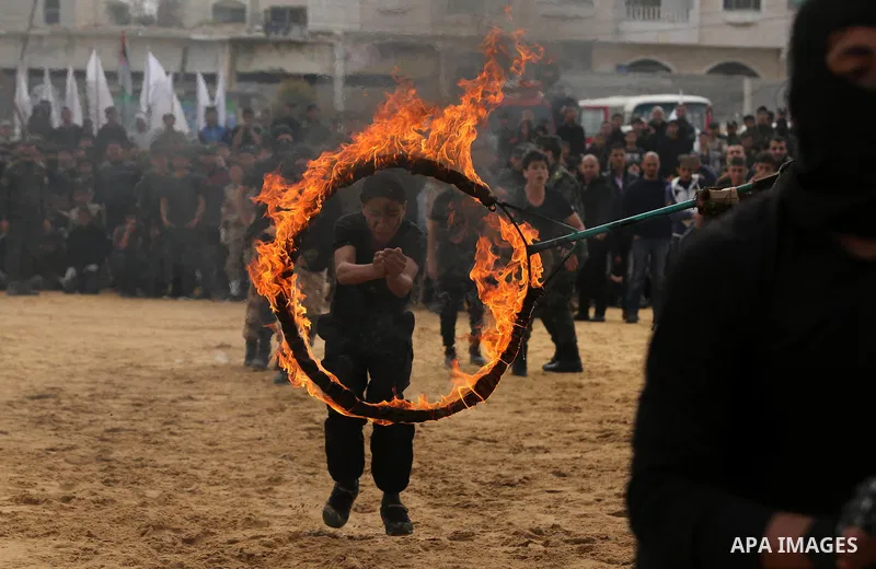 Palestinian high-school students show off their skills during a graduation ceremony from a military school course organised by the Palestinian security forces in Gaza strip, in Gaza City, on April 2, 2017. Photo by Ashra...