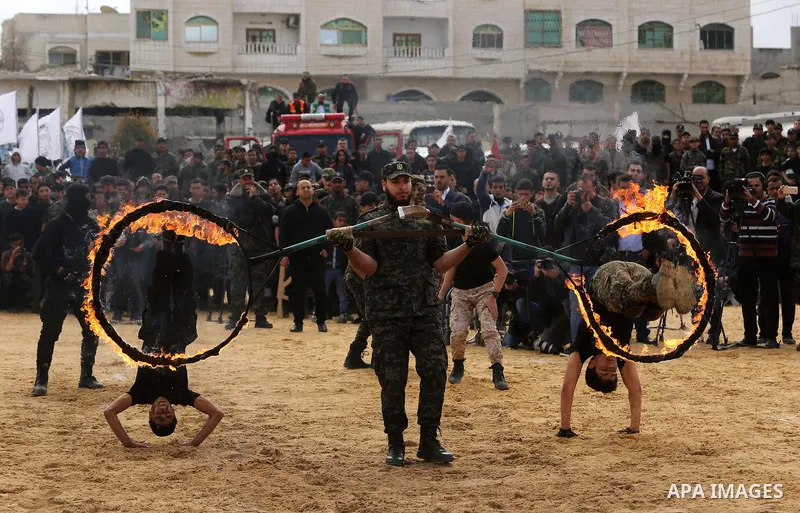 Palestinian high-school students show off their skills during a graduation ceremony from a military school course organised by the Palestinian security forces in Gaza strip, in Gaza City, on April 2, 2017. Photo by Ashra...