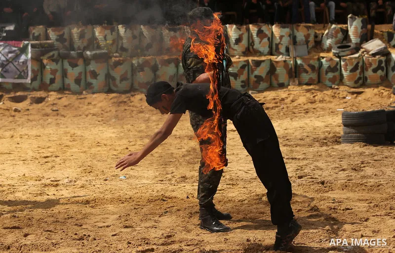 Palestinian high-school students show off their skills during a graduation ceremony from a military school course organised by the Palestinian security forces in Gaza strip, in Gaza City, on April 2, 2017. Photo by Ashra...