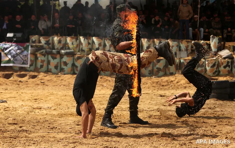 Palestinian high-school students show off their skills during a graduation ceremony from a military school course organised by the Palestinian security forces in Gaza strip, in Gaza City, on April 2, 2017. Photo by Ashra...