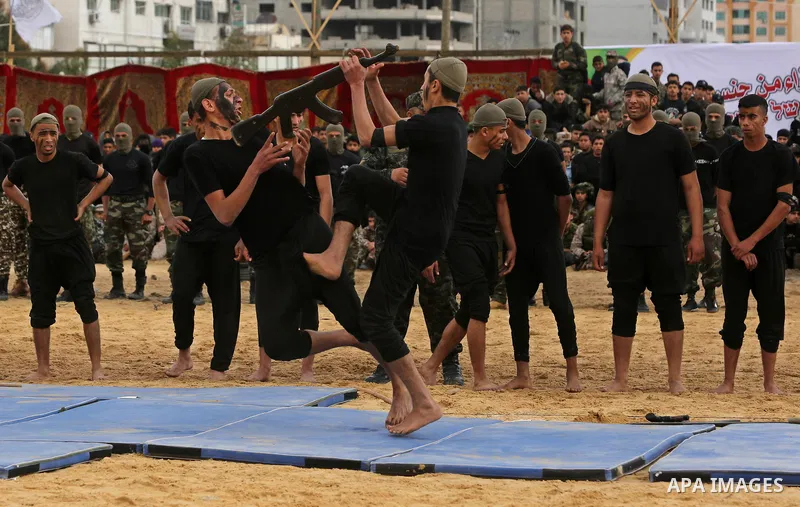 Palestinian high-school students show off their skills during a graduation ceremony from a military school course organised by the Palestinian security forces in Gaza strip, in Gaza City, on April 2, 2017. Photo by Ashra...