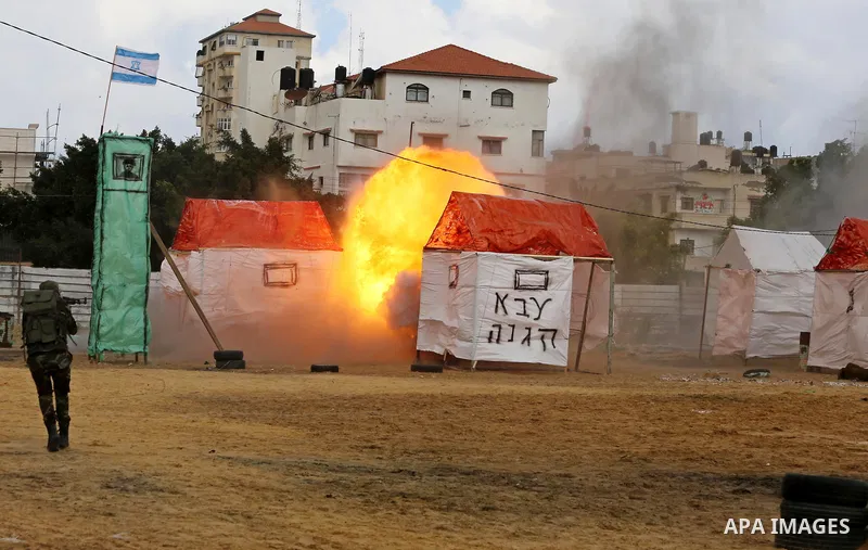 A fire is seen after a mock Israeli tank was blown up during a graduation ceremony from a military school course for Palestinian high-school students organised by the Palestinian security forces in Gaza strip, in Gaza Ci...