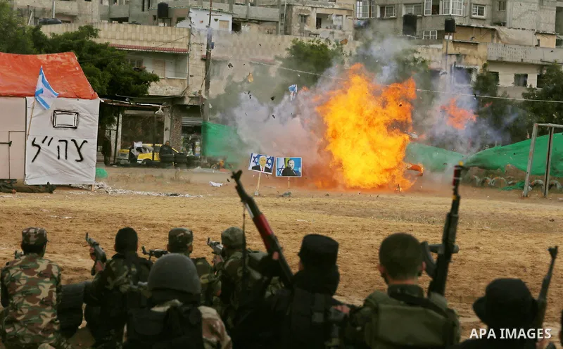 A fire is seen after a mock Israeli tank was blown up during a graduation ceremony from a military school course for Palestinian high-school students organised by the Palestinian security forces in Gaza strip, in Gaza Ci...