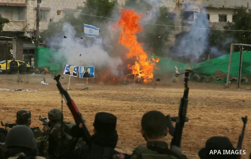 A fire is seen after a mock Israeli tank was blown up during a graduation ceremony from a military school course for Palestinian high-school students organised by the Palestinian security forces in Gaza strip, in Gaza Ci...