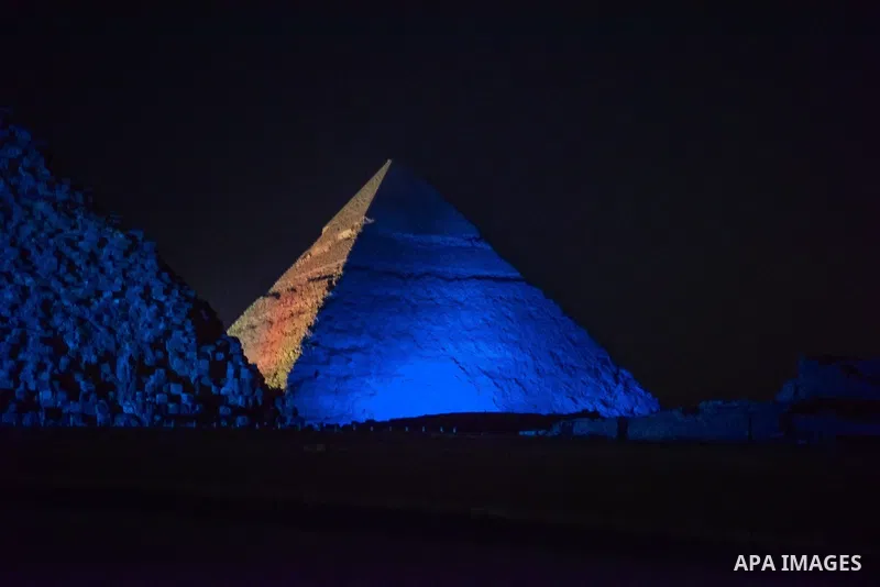 The Pyramid of Khufu, the largest of the Great Pyramids of Giza is lit in blue in honor of World Autism Awareness Day, on the outskirts of Cairo, Egypt on April 02, 2017. Photo by Amr Sayed