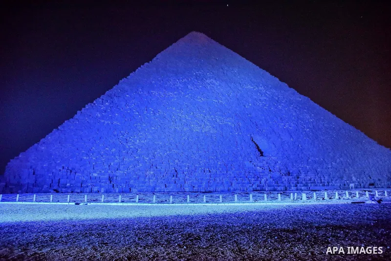 The Pyramid of Khufu, the largest of the Great Pyramids of Giza is lit in blue in honor of World Autism Awareness Day, on the outskirts of Cairo, Egypt on April 02, 2017. Photo by Amr Sayed