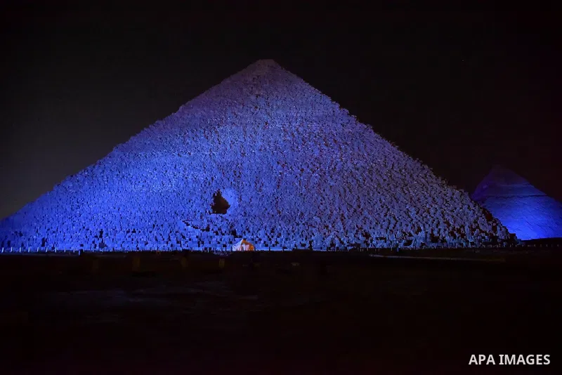 The Pyramid of Khufu, the largest of the Great Pyramids of Giza is lit in blue in honor of World Autism Awareness Day, on the outskirts of Cairo, Egypt on April 02, 2017. Photo by Amr Sayed